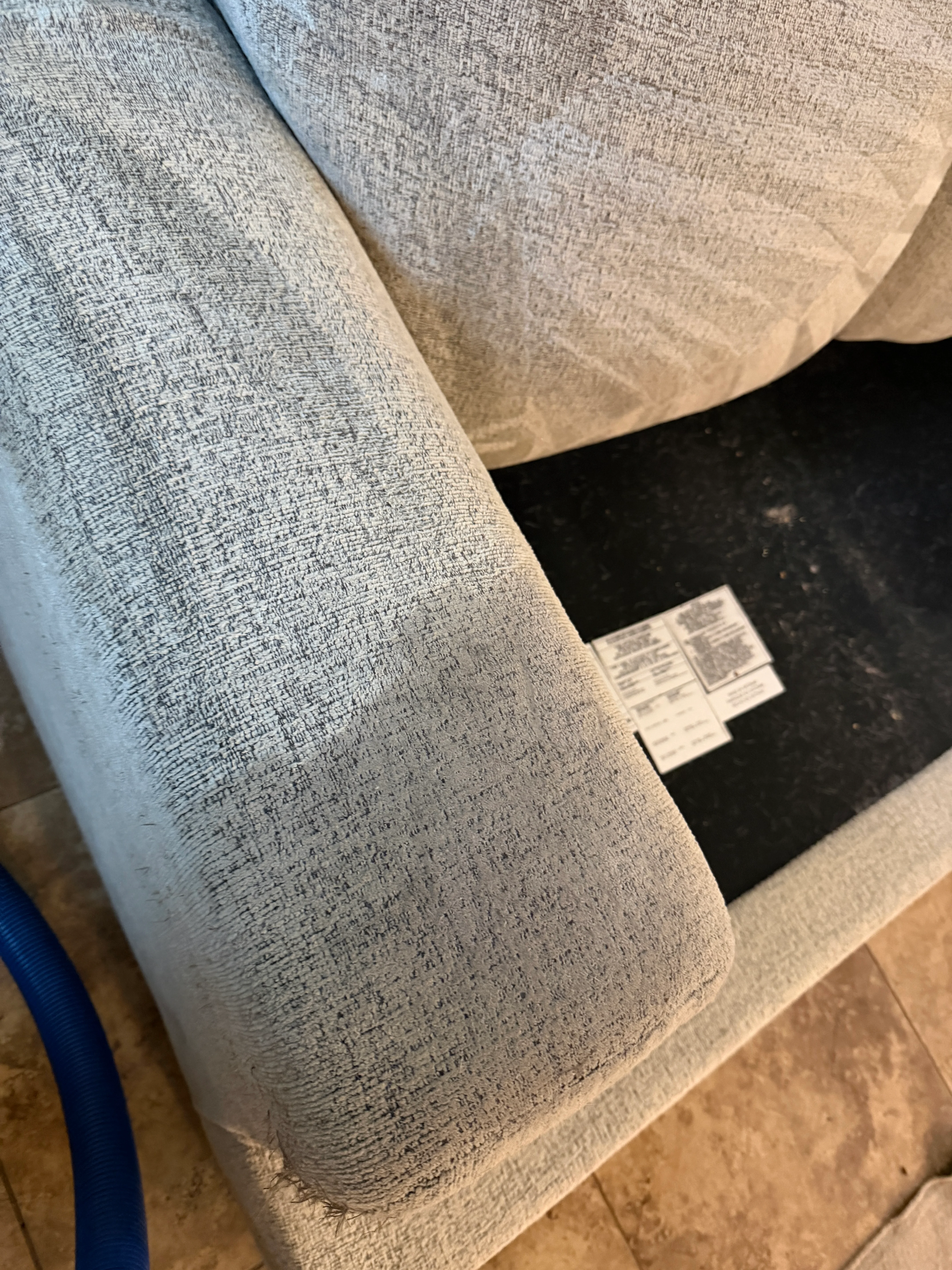 Light gray textured upholstery fabric on sofa after professional cleaning