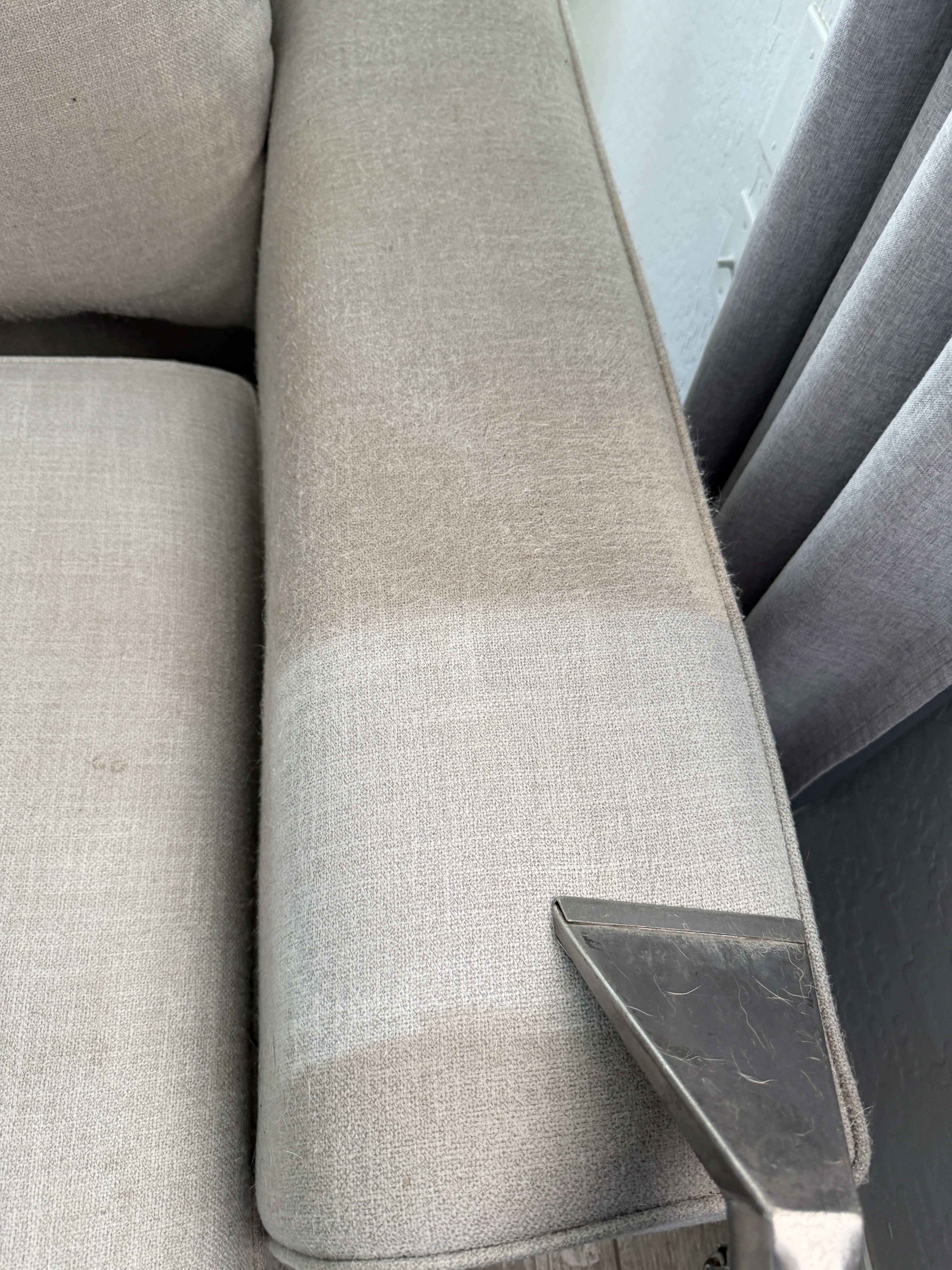 Upholstered sectional furniture showing cleaned beige and gray fabric surfaces with restoration results